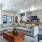 large couch with coffee table and tvs