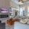 large room with couches tables and a tv