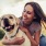 woman hugs her dog in a park
